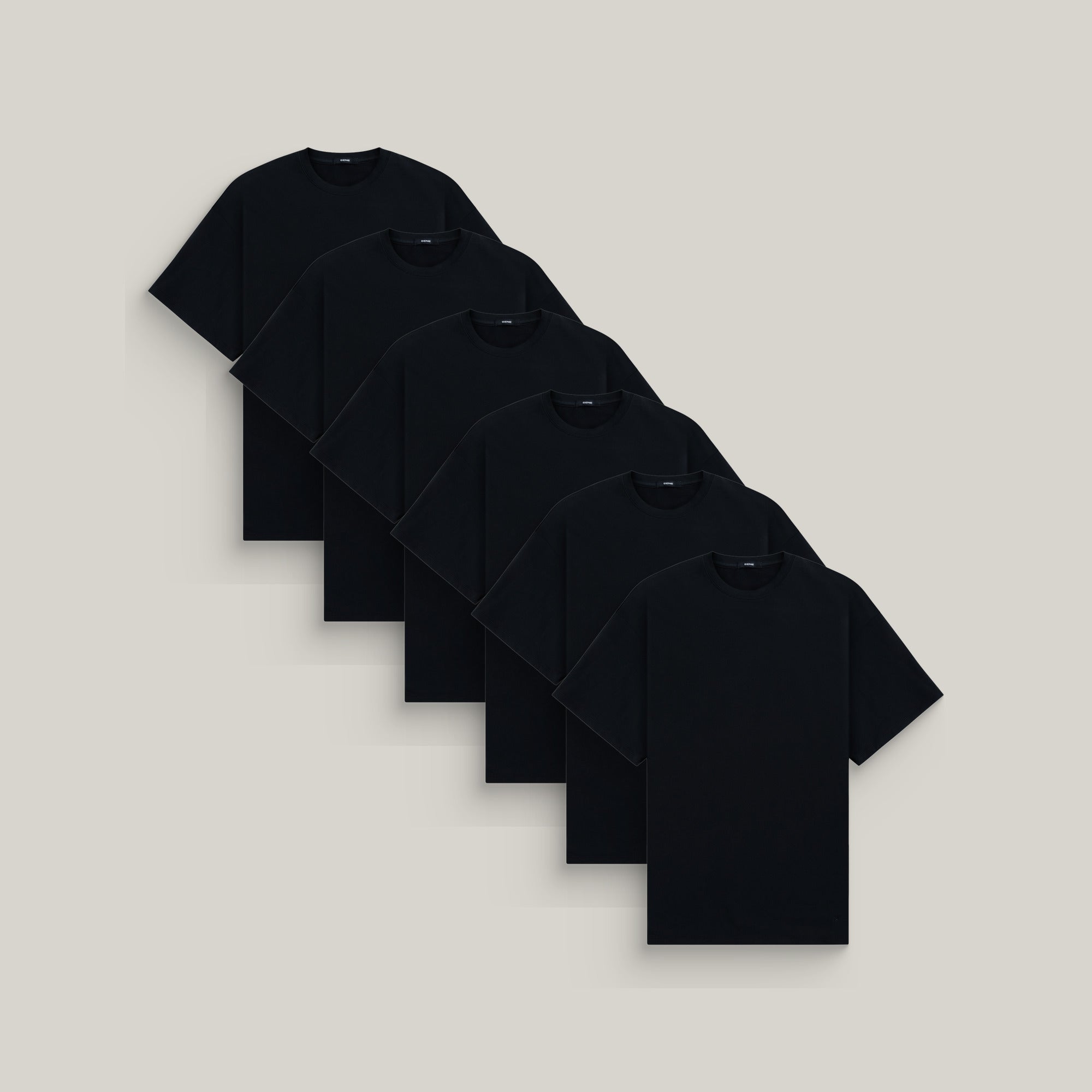 Six oversized t-shirts in black on a beige background model Kive in All-Black