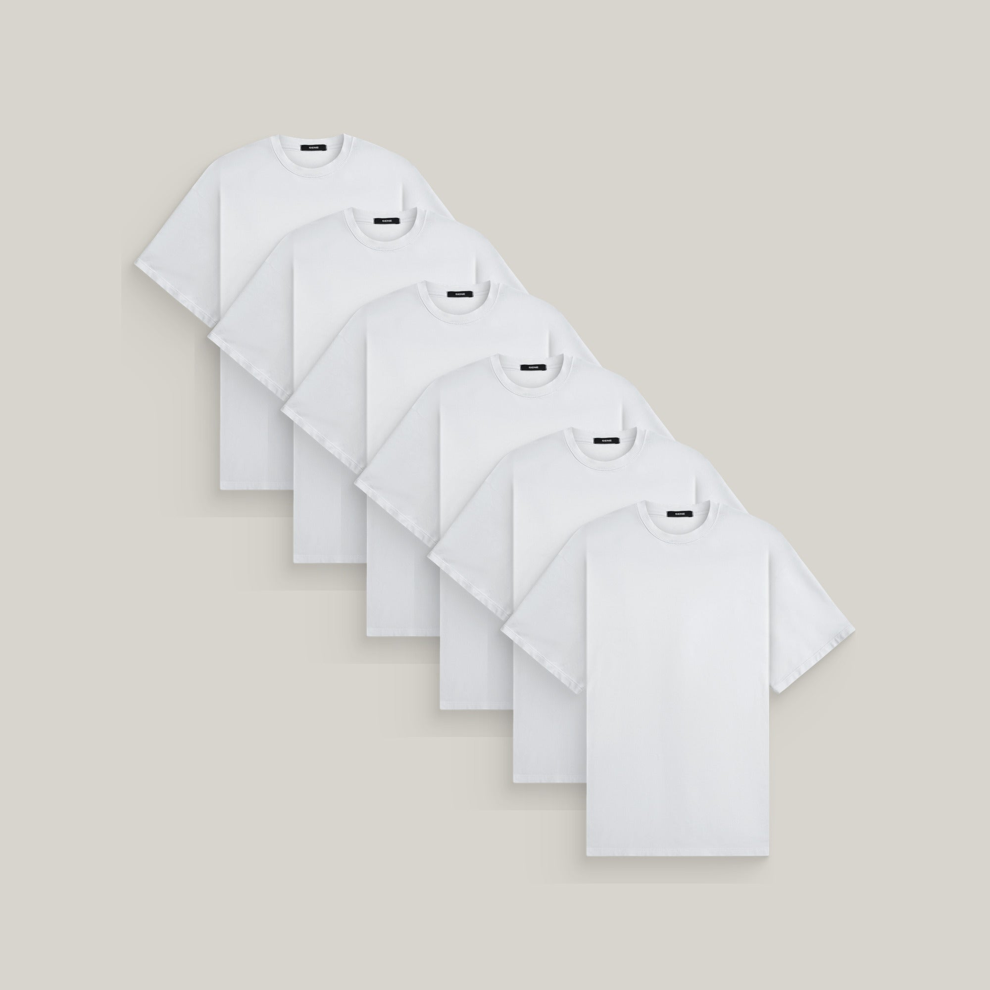Six oversized t-shirts in white on a beige background model Kive in All-White