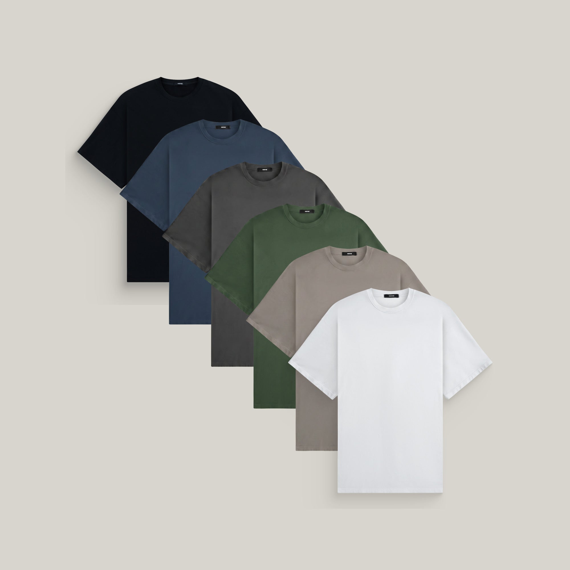 Six oversized t-shirts in black, deep sea, smoke, moss, frost gray and white on a beige background model Kive in Best-Seller
