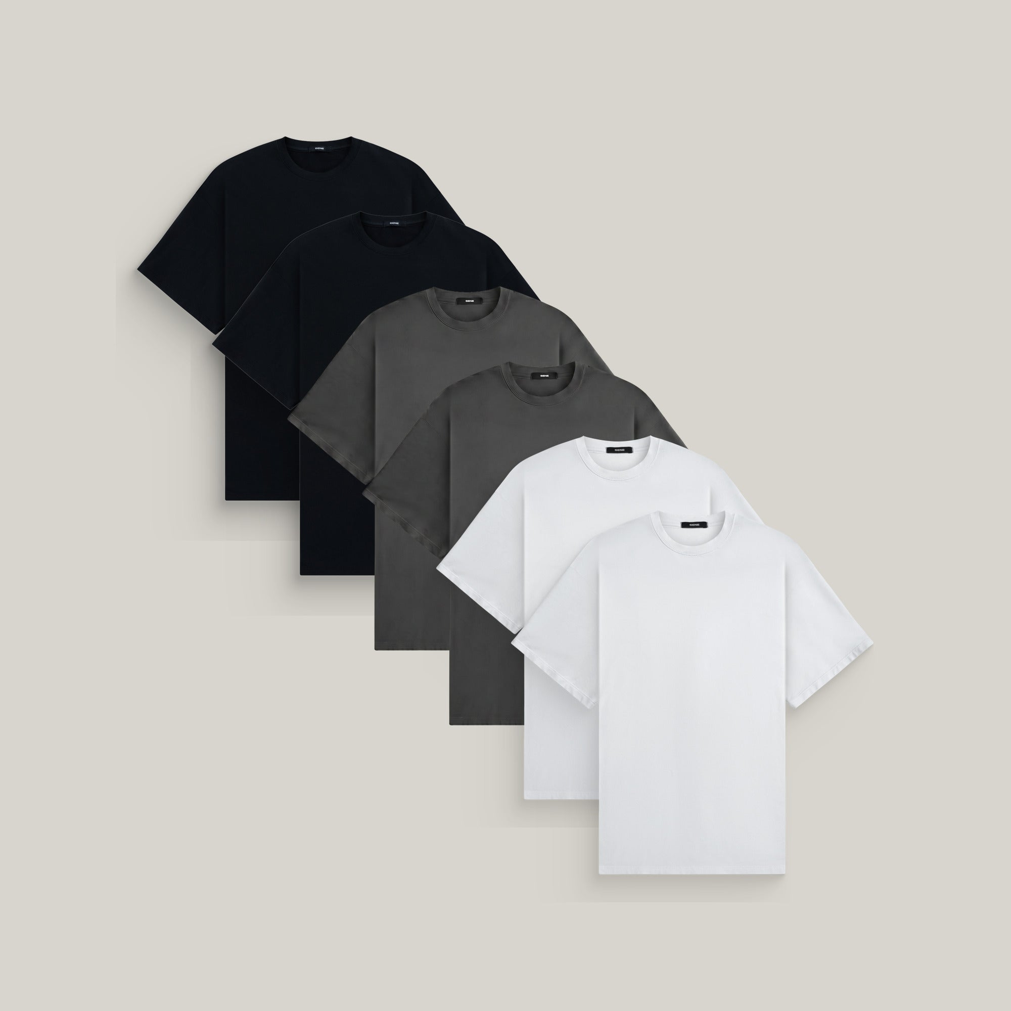 Six oversized t-shirts in black, smoke and white on a beige background model Kive in Core