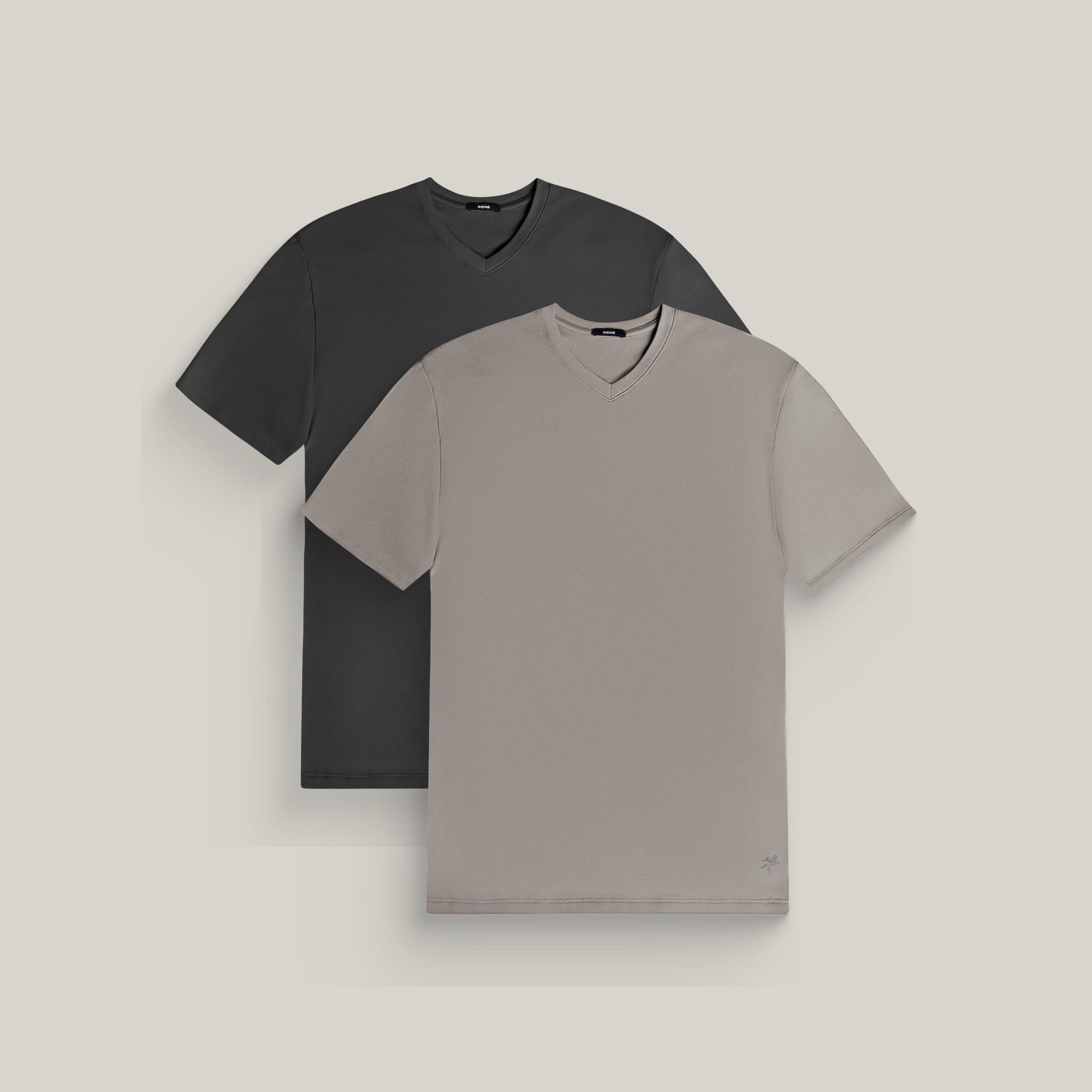 Two v-neck t-shirts in smoke and frost gray on a beige background model Tyler in Canyon