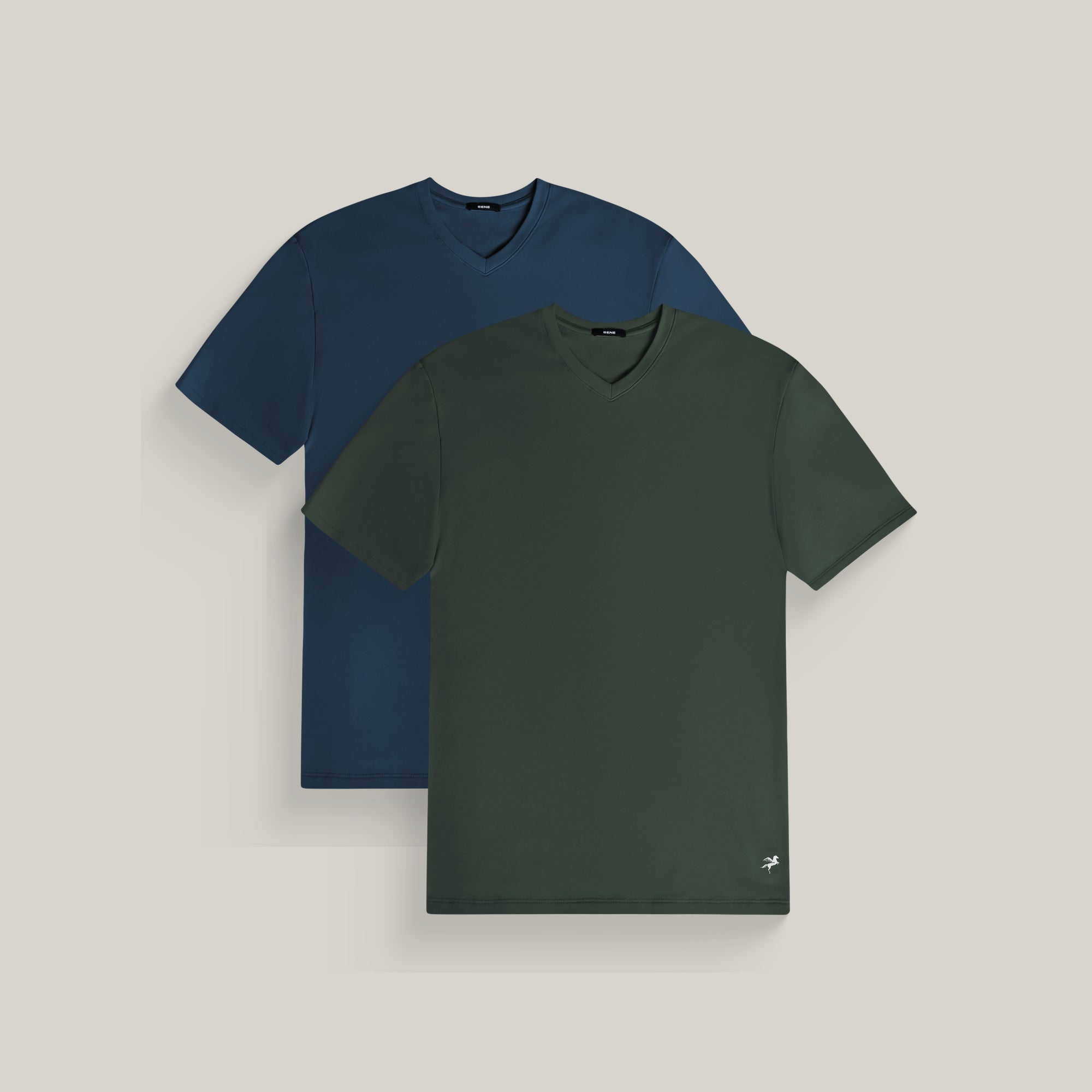 Two v-neck t-shirts in deep sea and moss on a beige background model Tyler in Coast