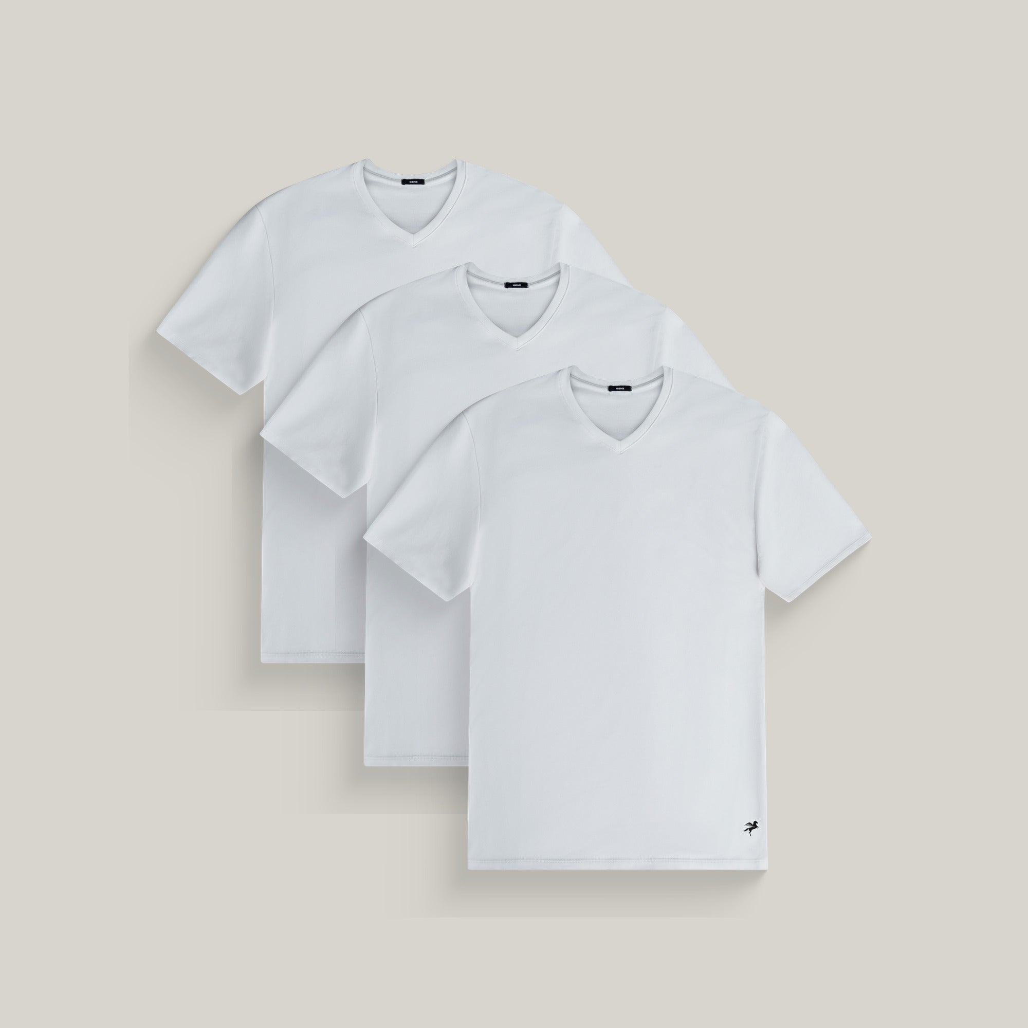 Three v-neck t-shirts in white on a beige background model Tyler in All-White