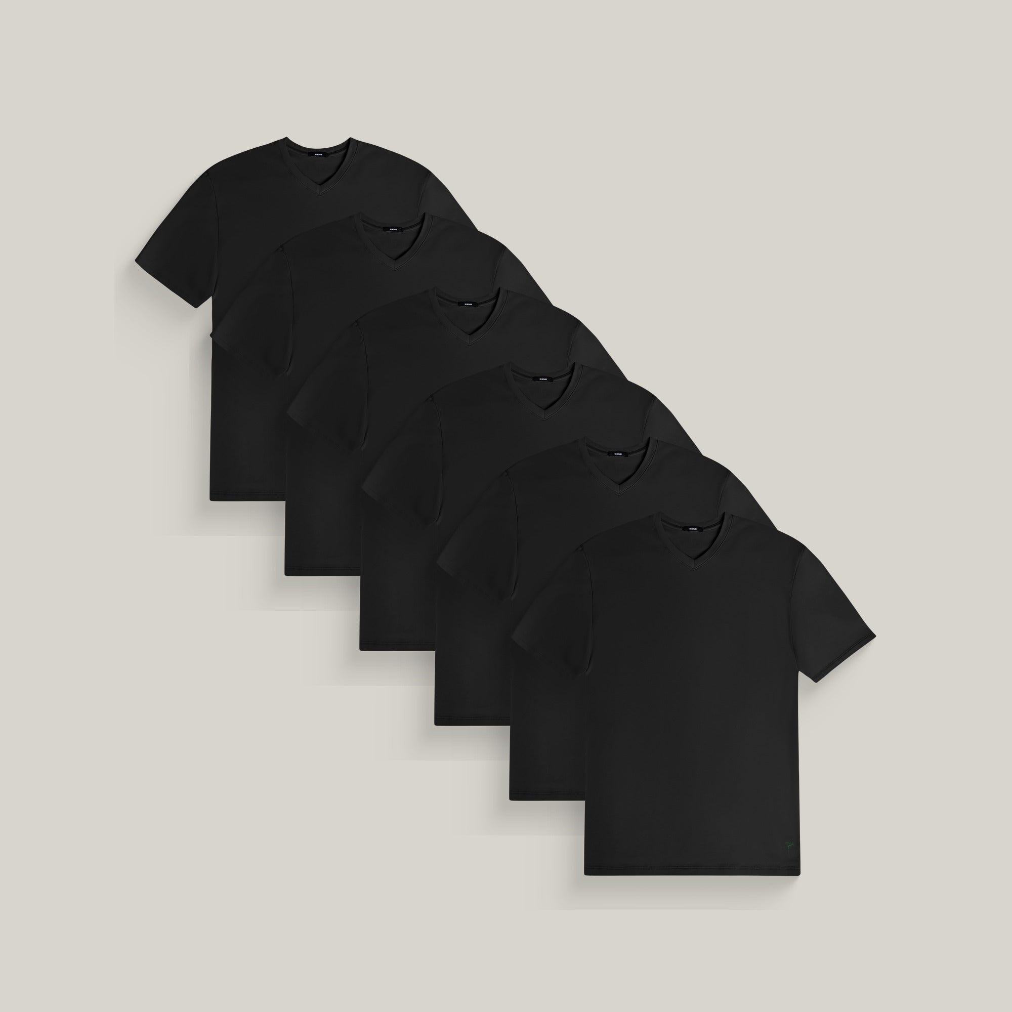 Six v-neck t-shirts in black on a beige background model Tyler in All-Black